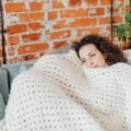 Woman wrapped in a cozy blanket enjoying soothing warmth and comfort