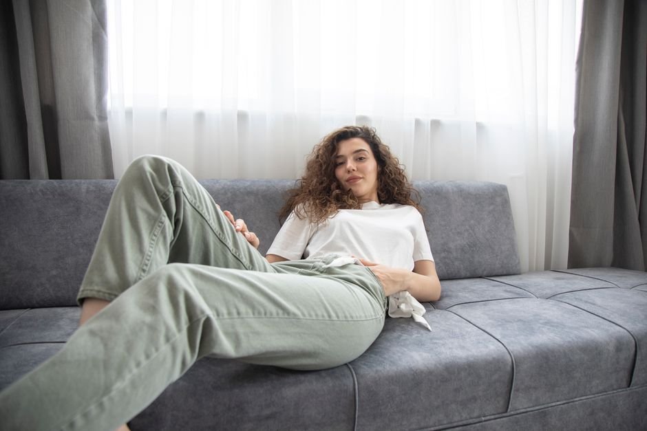 Woman relaxing comfortably on a couch at home