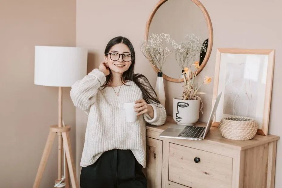 Woman enjoying a bright, cozy morning with coffee and a lamp