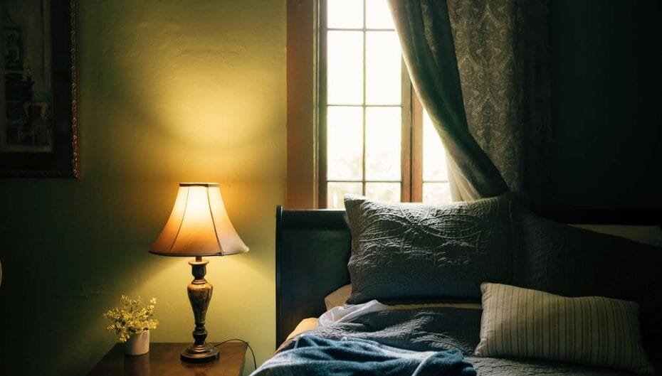 Calm, cozy bedroom with a softly glowing nightstand lamp for restful sleep