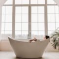 Woman relaxing in a bathtub with a supportive bath pillow for a spa soak
