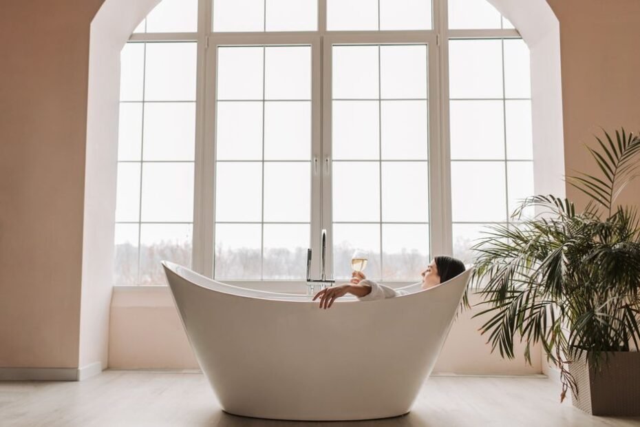 Woman relaxing in a bathtub with a supportive bath pillow for a spa soak