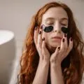 Woman relaxing with a cooling eye mask to soothe puffy, tired eyes