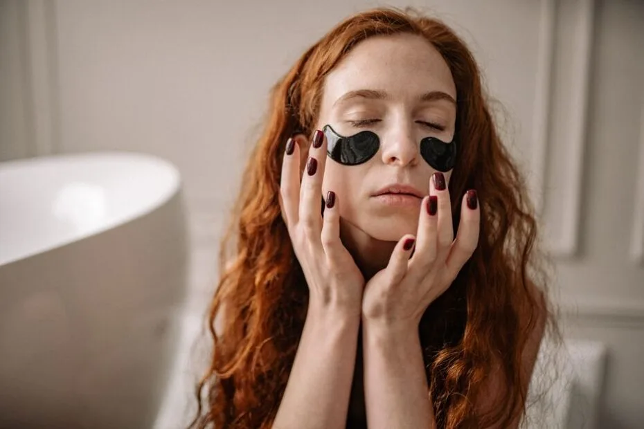 Woman relaxing with a cooling eye mask to soothe puffy, tired eyes