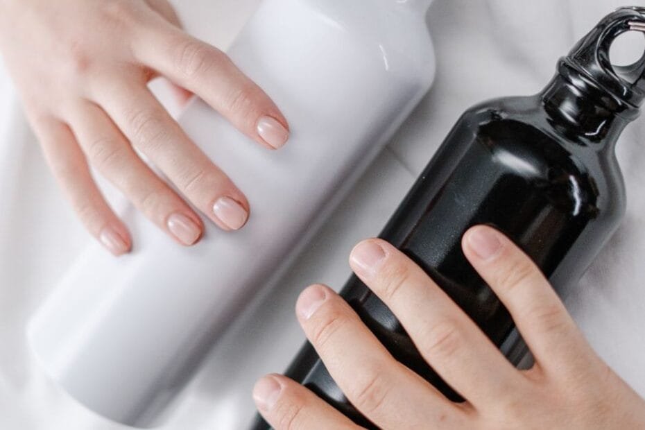 Insulated reusable water bottles held in hands