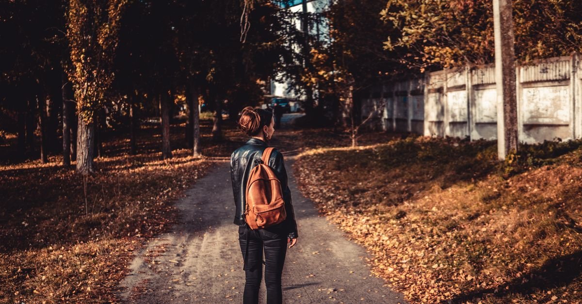 Person walking slowly along an autumn path