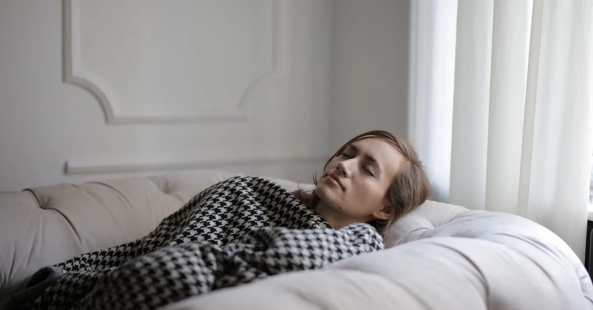 A person resting peacefully in bed