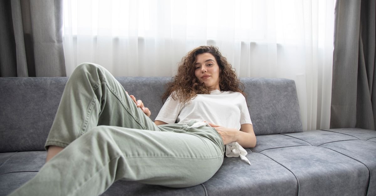 Woman resting and relaxing on a sofa at home
