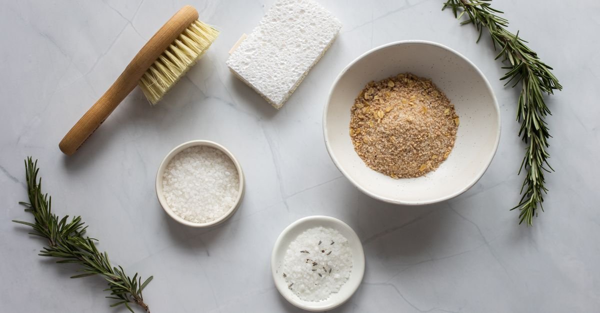 Flat lay of spa and self-care essentials with a dry brush and bowls