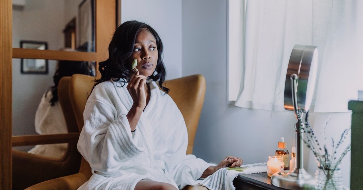 Woman in a robe taking a quiet, relaxed self-care moment