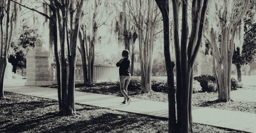 Woman walking mindfully in a park