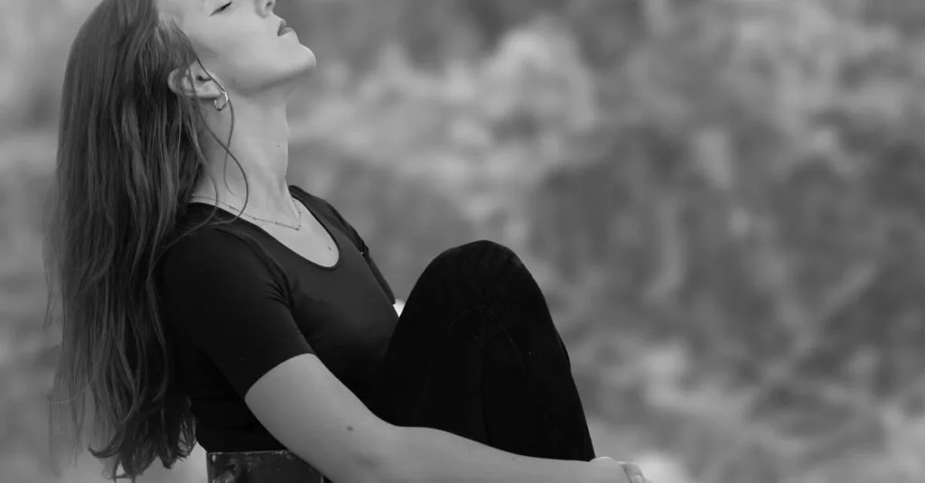 Woman calming herself outdoors