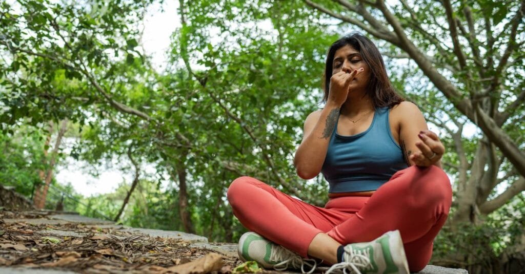 Woman practicing breathwork outdoors
