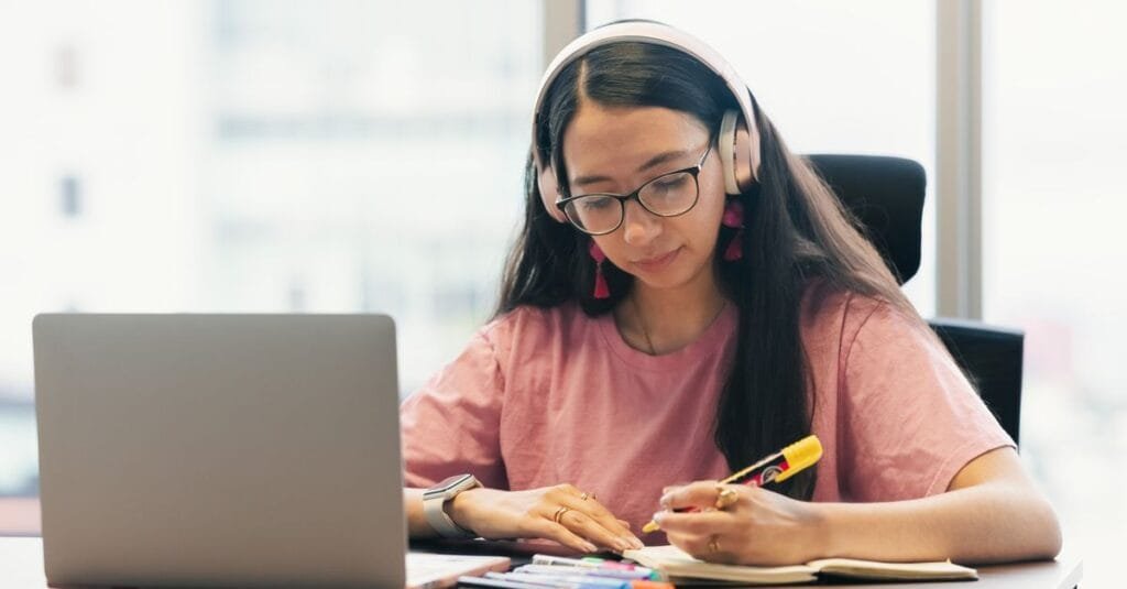 Student studying with headphones