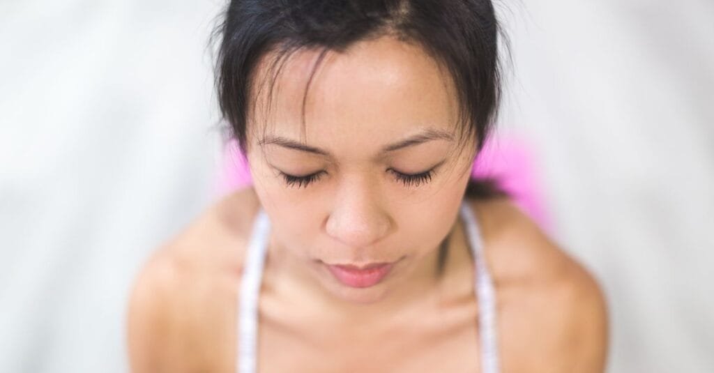 Woman doing a breathing exercise indoors