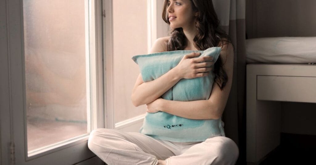 Woman resting by a window, doing nothing