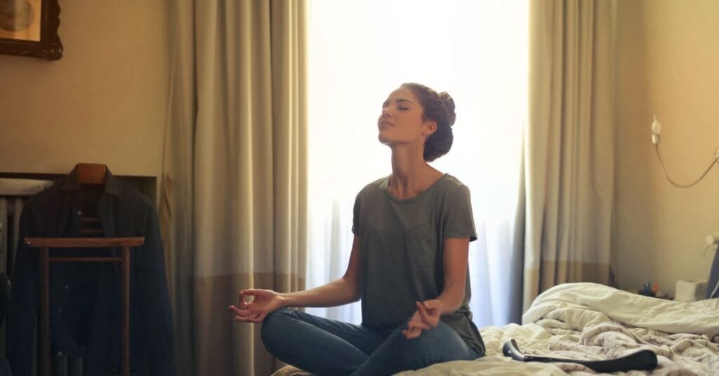 Meditating in bed to relax