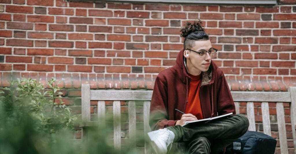 A student taking notes on campus