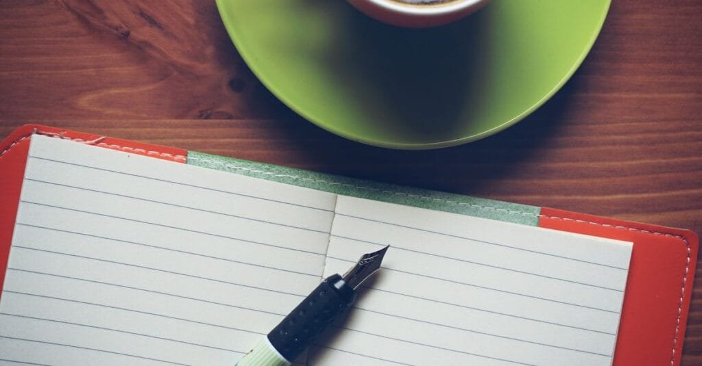 A notebook, pen and coffee ready for writing